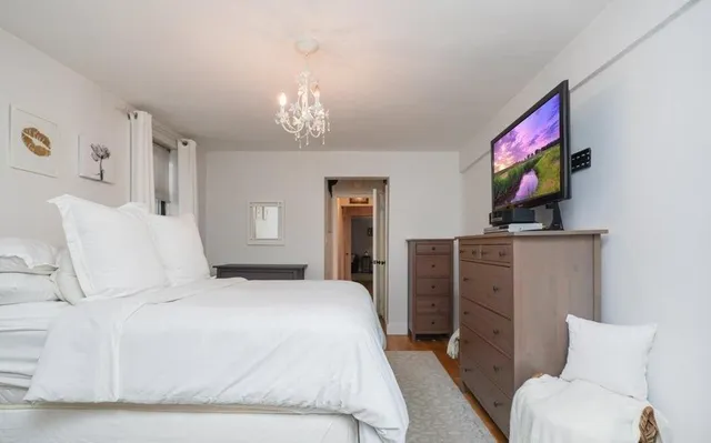 a bedroom with a bed and a flat screen tv