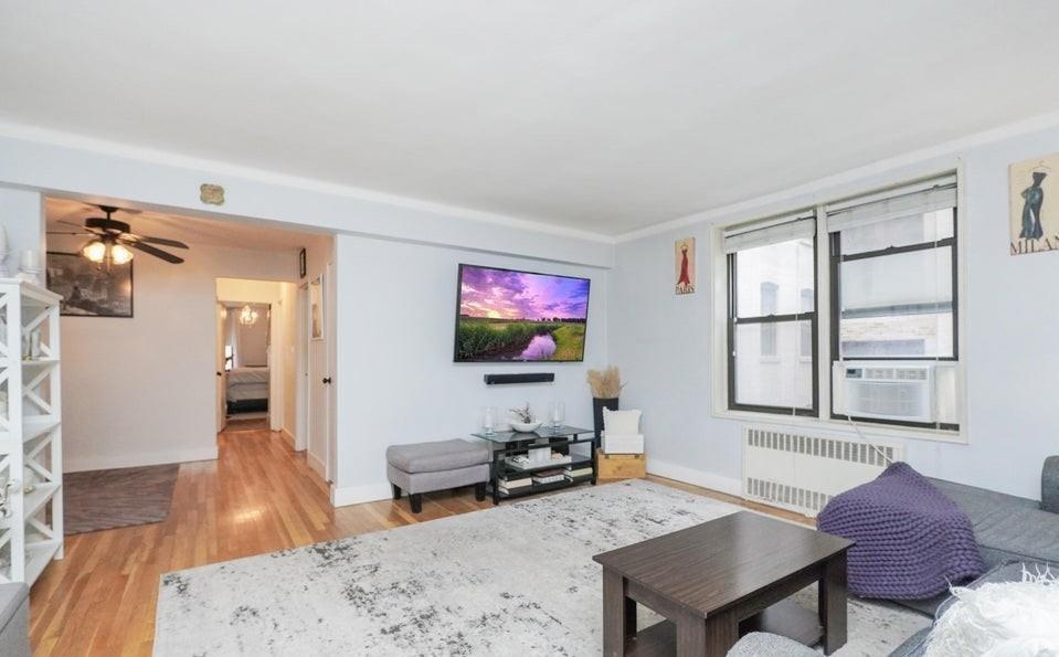 61 Oliver Street, Unit 2V Brooklyn, NY 11209 - Photo 8 of 23 a living room with furniture and a flat screen tv