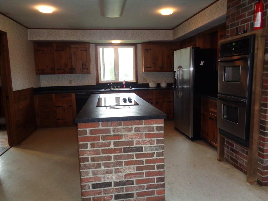 47 Main Road Abbot, ME 04406 - Photo 3 of 22 Brick island with cook top and...