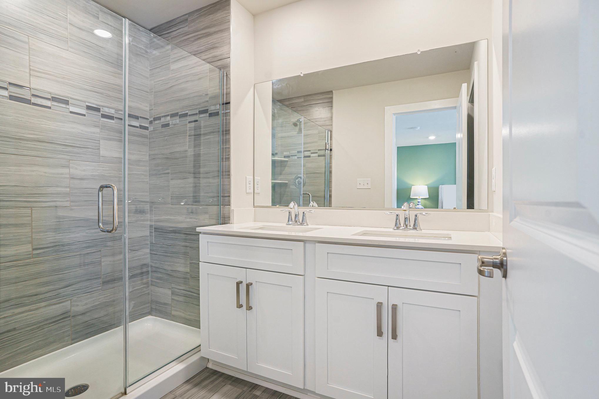 218 Red Leaf Lane Exton, PA 19341 - Photo 19 of 29 a bathroom with a shower sink and mirror