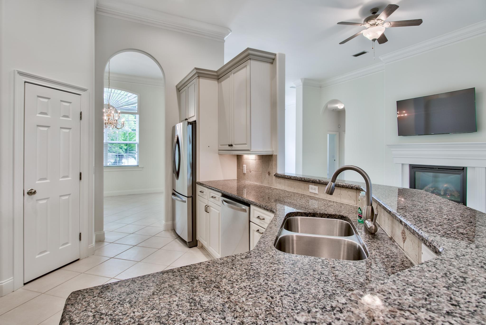 359 Indigo Loop Miramar Beach, FL 32550 - Photo 11 of 47 a kitchen with stainless steel appliances granite countertop a sink a refrigerator and a granite counter tops