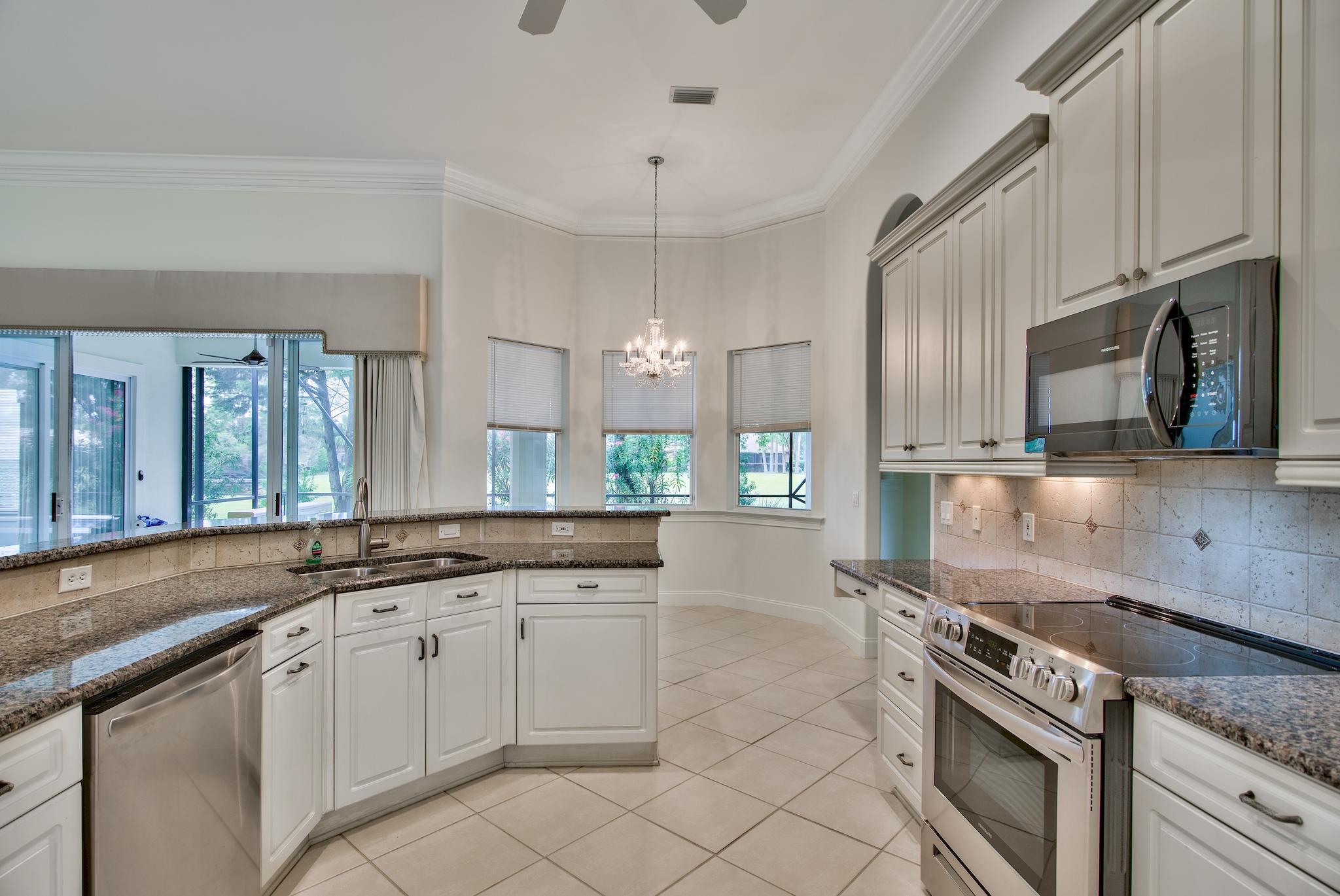 359 Indigo Loop Miramar Beach, FL 32550 - Photo 14 of 47 a kitchen with granite countertop a sink stainless steel appliances and cabinets
