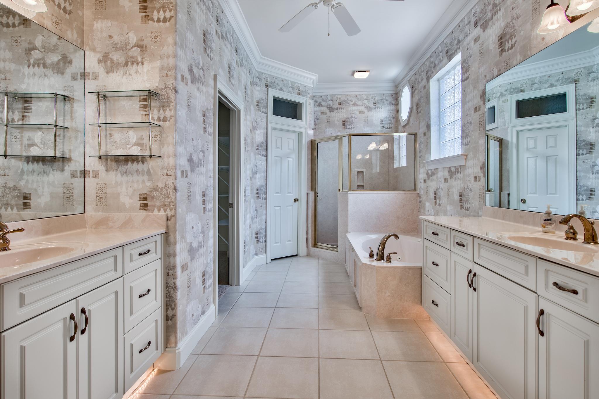 359 Indigo Loop Miramar Beach, FL 32550 - Photo 23 of 47 a spacious bathroom with a double vanity sink a large mirror and a bathtub
