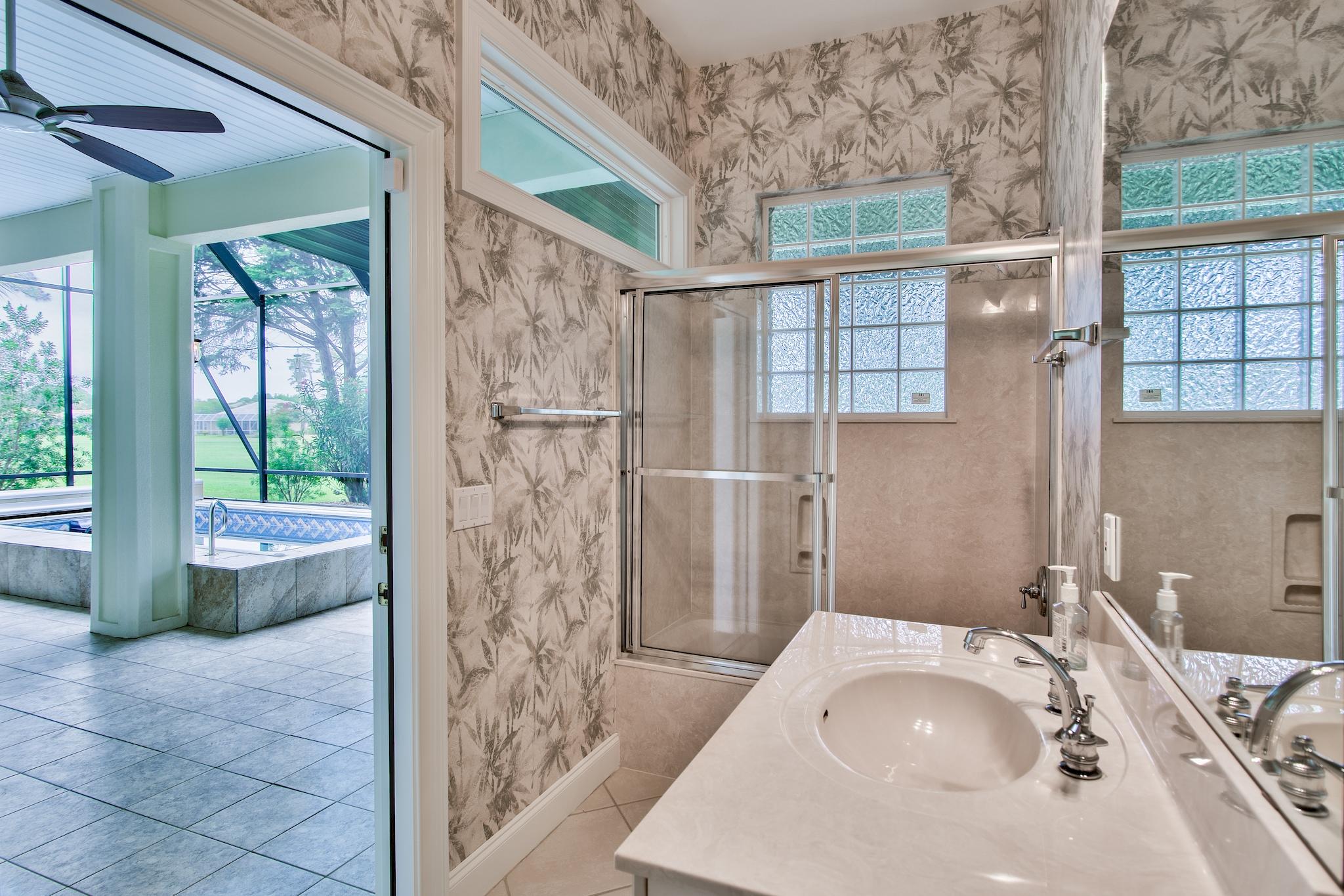 359 Indigo Loop Miramar Beach, FL 32550 - Photo 25 of 47 a bathroom with a tub sink and glass door