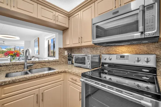 a kitchen with a stove microwave and sink