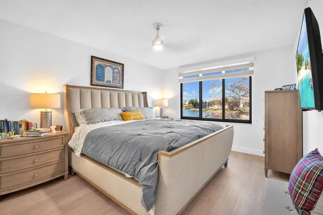 a bed sitting in a bedroom next to a window