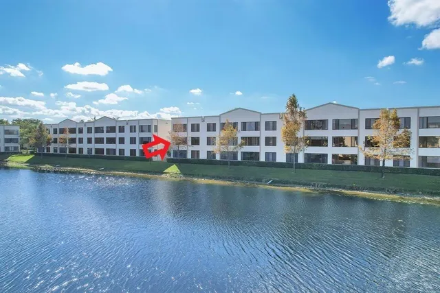 a view of building with river and outdoor space