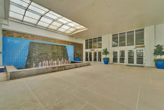 a view of a brick building with a small yard