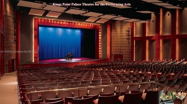 a room with wooden floor pool table and chairs