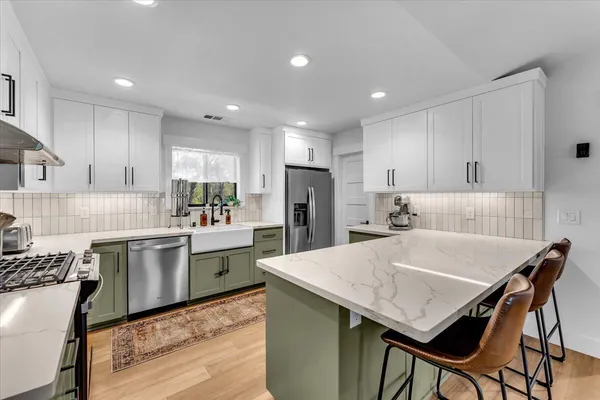 a kitchen with a sink stove and cabinets
