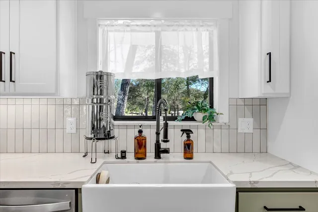 a kitchen with a stove a sink dishwasher and a refrigerator with wooden floor