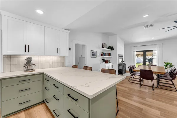 a view of a kitchen with a sink and washer dryer