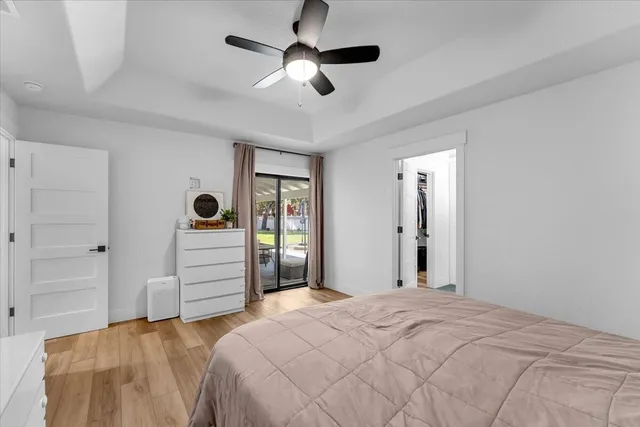 a bedroom with furniture and a ceiling fan