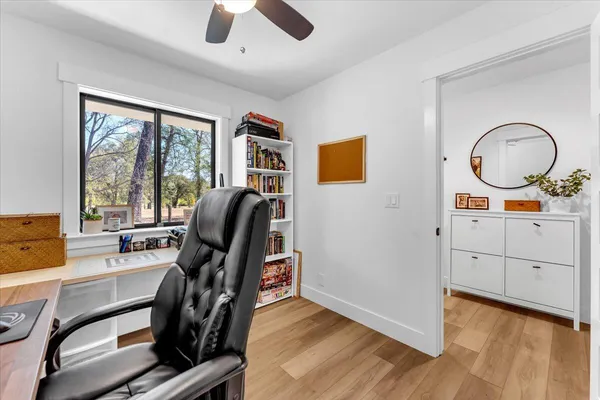 a view of a house with backyard and sitting area
