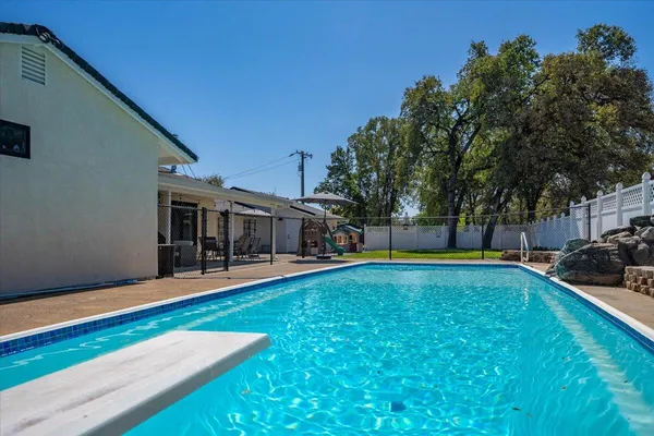 a view of a patio with table and chairs and potted plants