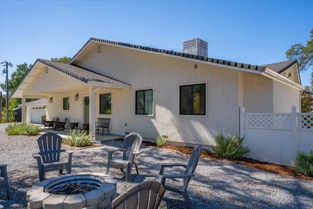 a living room with furniture and a view of kitchen