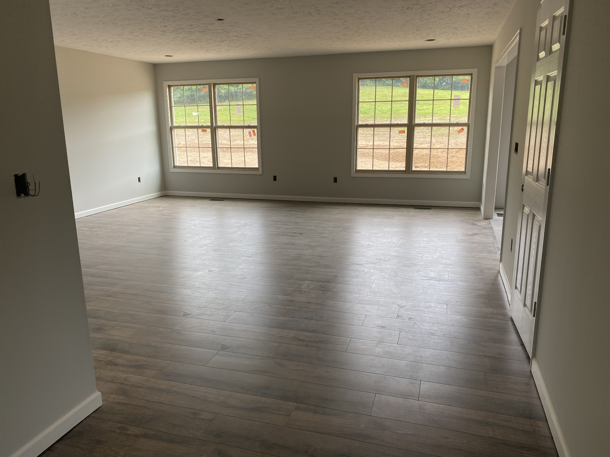 767 Jarrell Road Manchester, TN 37355 - Photo 2 of 8 an empty room with wooden floor and windows