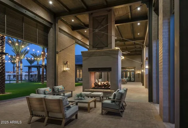a living room with patio furniture and a fireplace