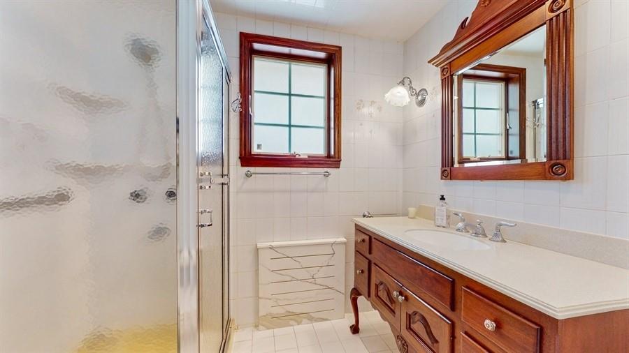 169 84th Street Brooklyn, NY 11209 - Photo 20 of 40 a bathroom with a sink a vanity and a shower