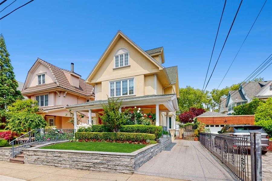 169 84th Street Brooklyn, NY 11209 - Photo 2 of 40 a view of a white house with a small yard and potted plants