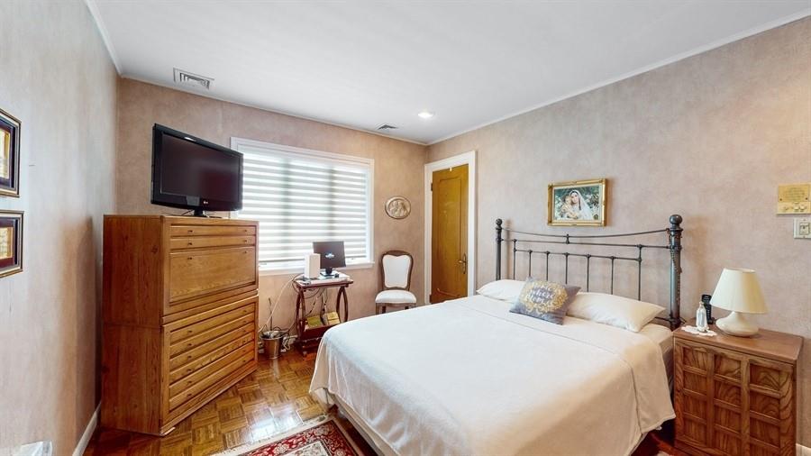 169 84th Street Brooklyn, NY 11209 - Photo 21 of 40 a bedroom with a bed and a flat screen tv