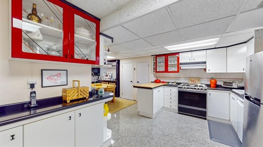169 84th Street Brooklyn, NY 11209 - Photo 29 of 40 a kitchen with kitchen island granite countertop a sink cabinets and stainless steel appliances