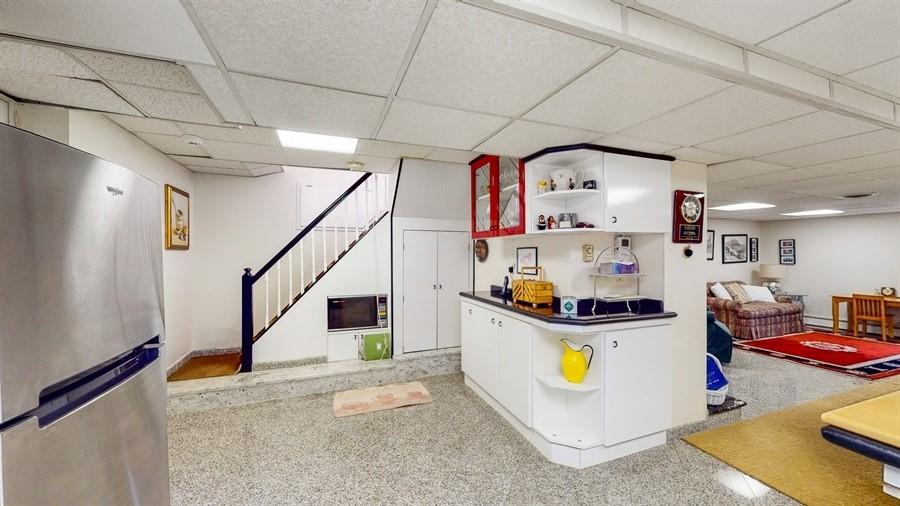 169 84th Street Brooklyn, NY 11209 - Photo 30 of 40 a kitchen with stainless steel appliances a stove a refrigerator and white cabinets