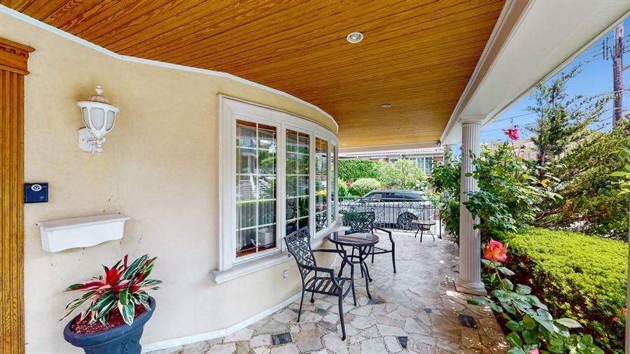 169 84th Street Brooklyn, NY 11209 - Photo 3 of 40 a patio with table and chairs and potted plants