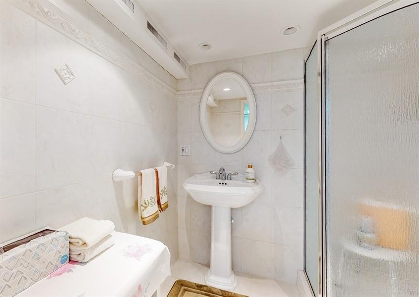 169 84th Street Brooklyn, NY 11209 - Photo 32 of 40 a bathroom with a sink mirror and toilet