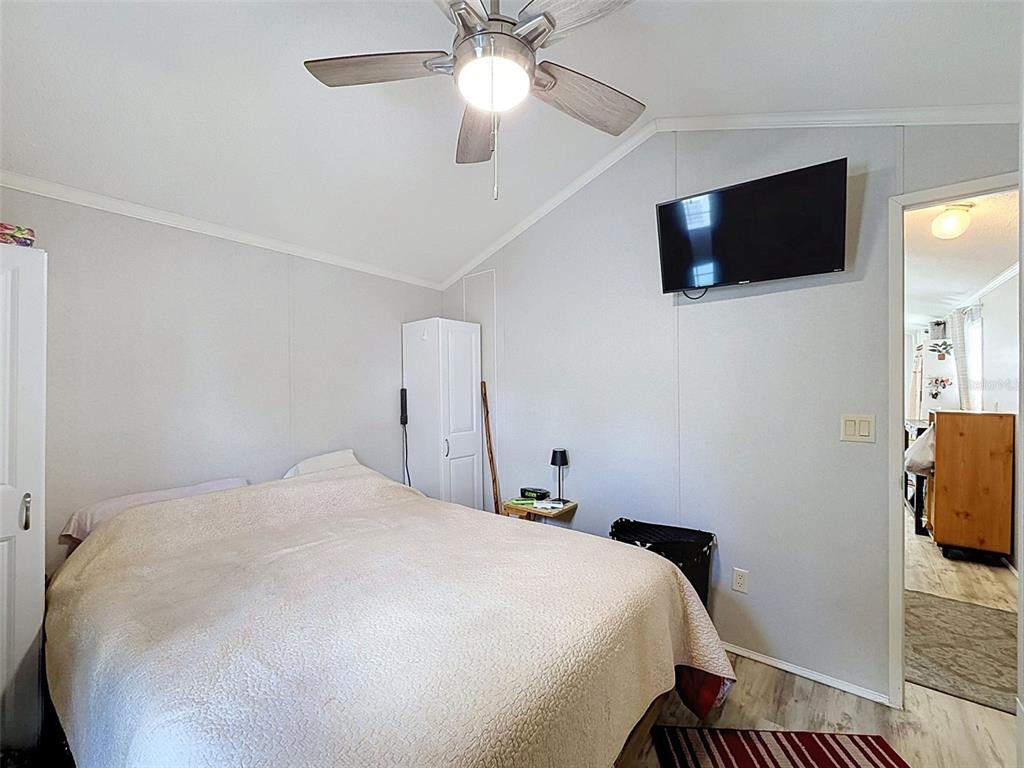 2092 Culbreath Road, Unit A42 Brooksville, FL 34602 - Photo 59 of 70 a bedroom with a bed and a flat screen tv