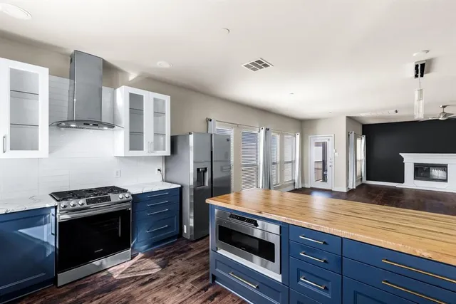 a kitchen with stainless steel appliances granite countertop a stove and a sink