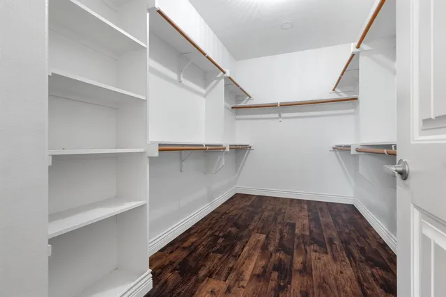 a view of a room with wooden floor