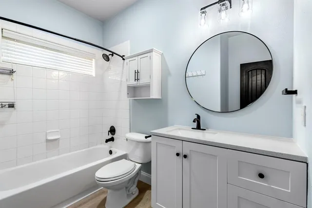 a bathroom with a sink a toilet and a mirror