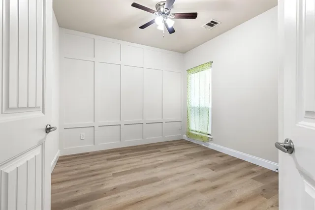 wooden floor in an empty room with a window