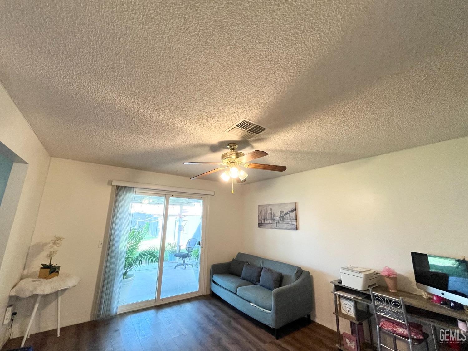Undisclosed Address Bakersfield, CA 93304 - Photo 15 of 33 a living room with furniture and a flat screen tv