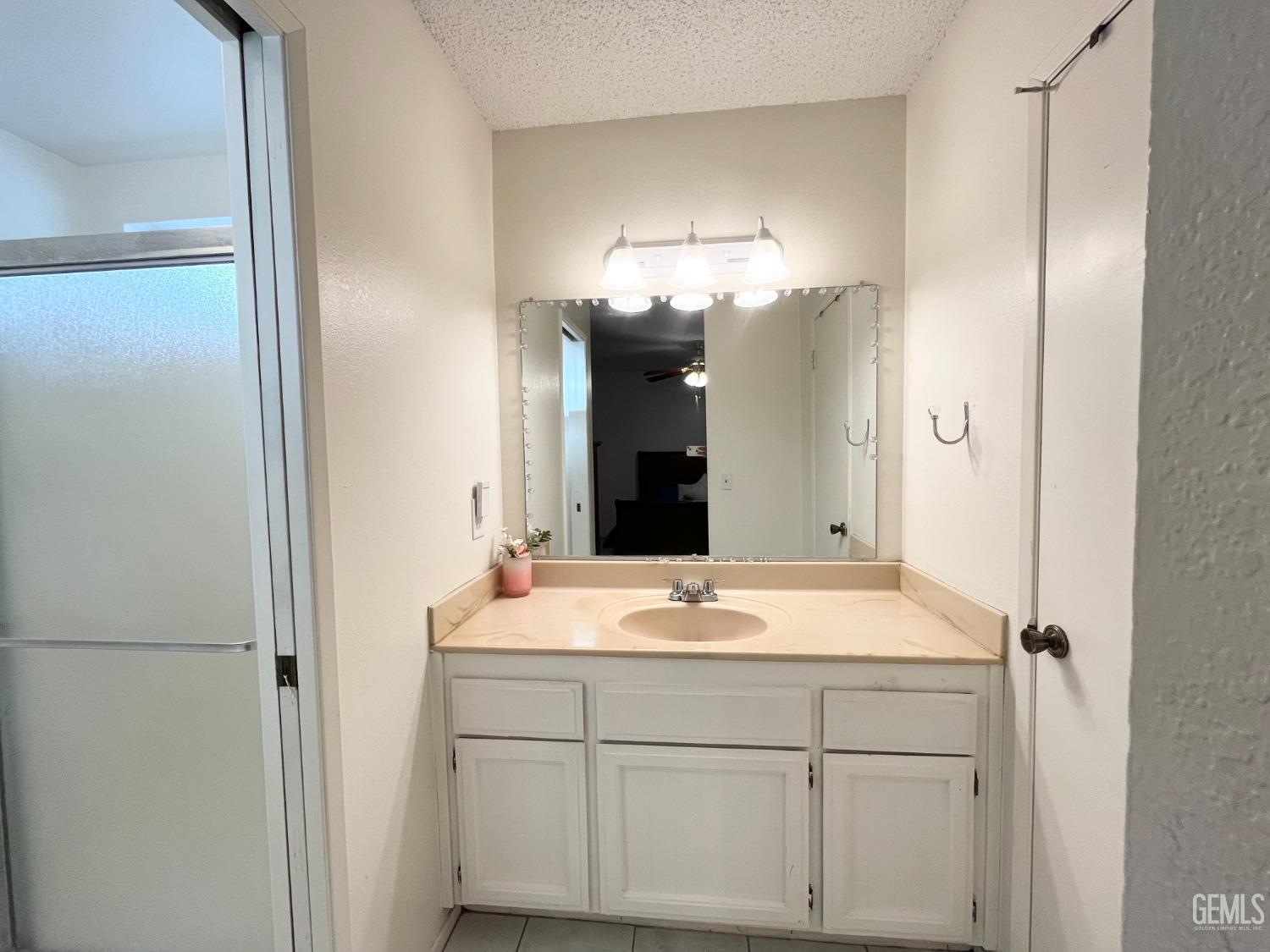 Undisclosed Address Bakersfield, CA 93304 - Photo 20 of 33 a bathroom with a sink and a mirror