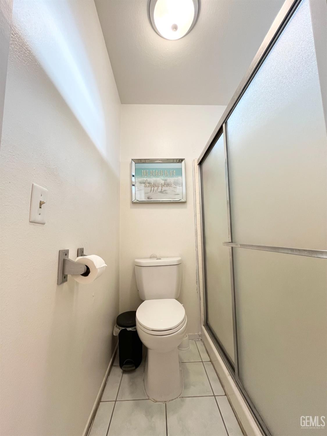 Undisclosed Address Bakersfield, CA 93304 - Photo 21 of 33 a bathroom with a toilet and a shower