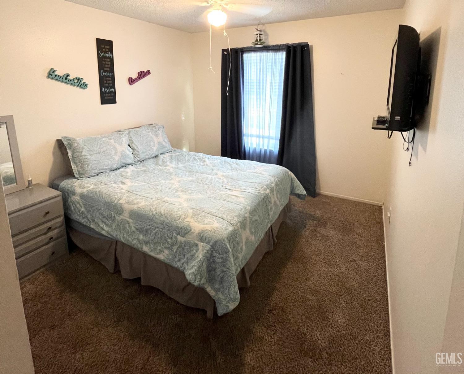Undisclosed Address Bakersfield, CA 93304 - Photo 23 of 33 a large bed sitting in a bedroom next to a window