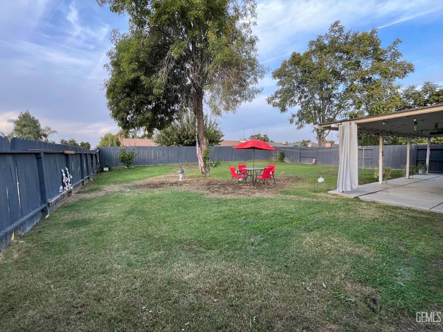 Undisclosed Address Bakersfield, CA 93304 - Photo 31 of 33 a view of a backyard with a garden and trees