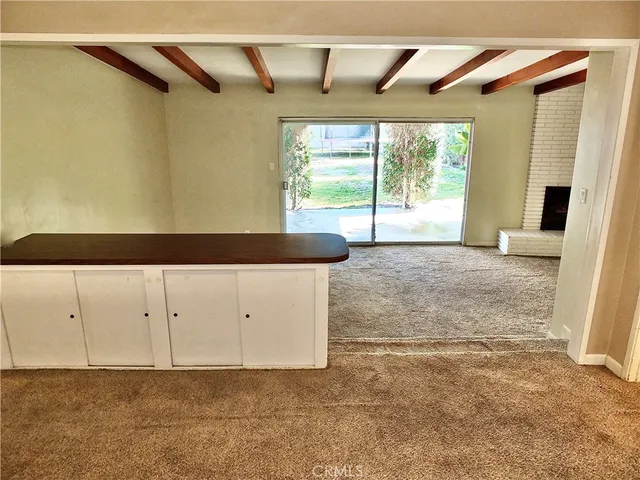 a view of a livingroom with a dishwasher and a window