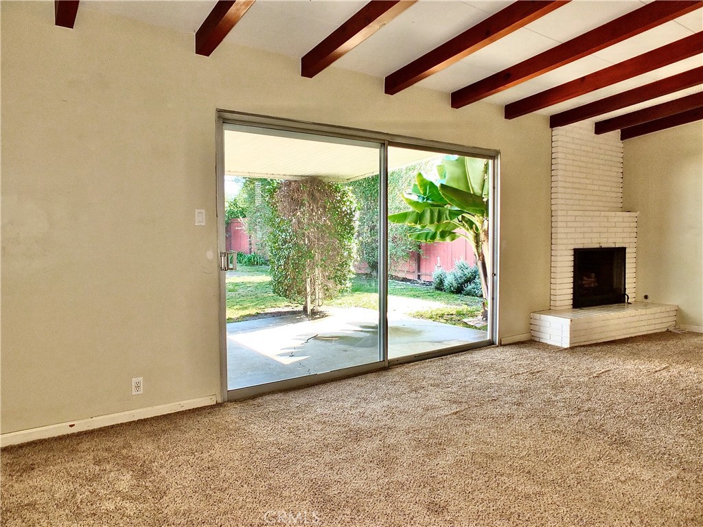 2024 San Anseline Avenue Long Beach, CA 90815 - Photo 18 of 36 an empty room with floor to ceiling windows and a fireplace