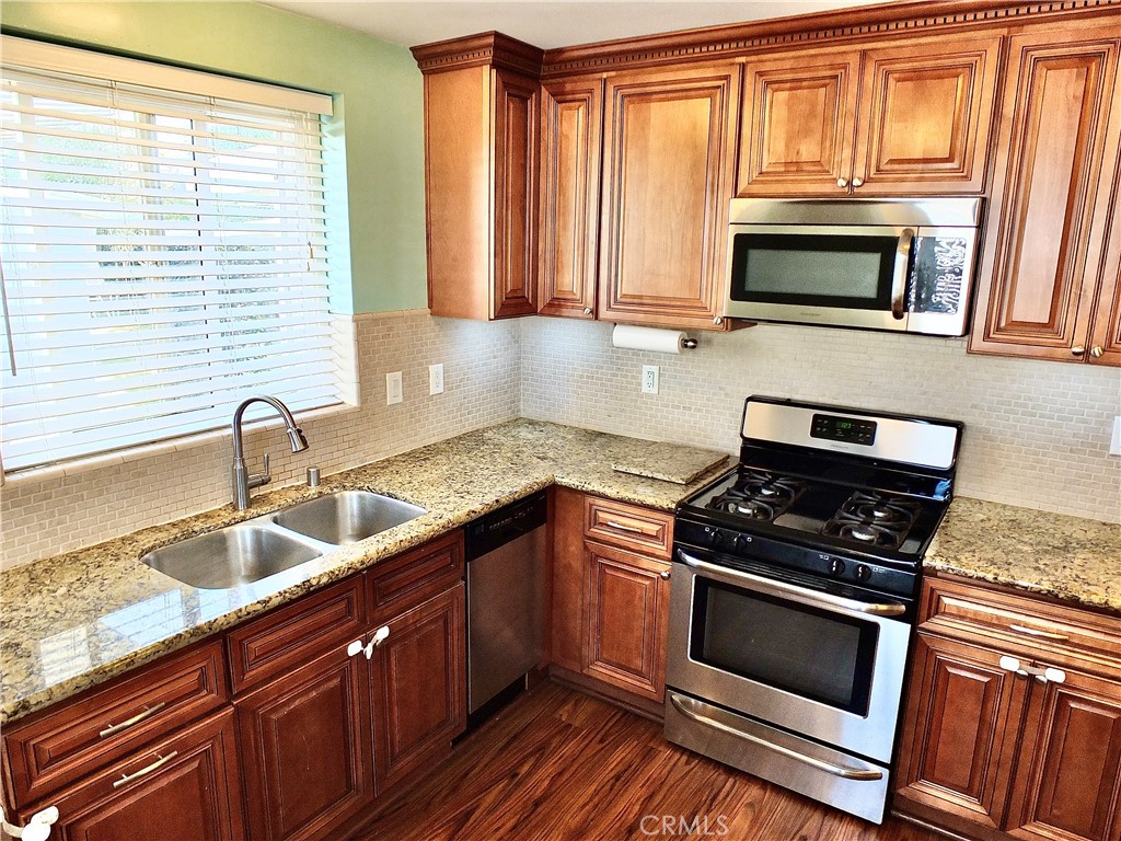 2024 San Anseline Avenue Long Beach, CA 90815 - Photo 2 of 36 a kitchen with granite countertop a sink and steel appliances
