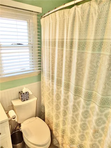 a white toilet sitting next to a bathroom sink