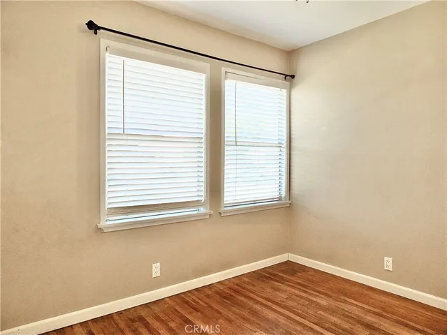 a view of a room with wooden floor and a window