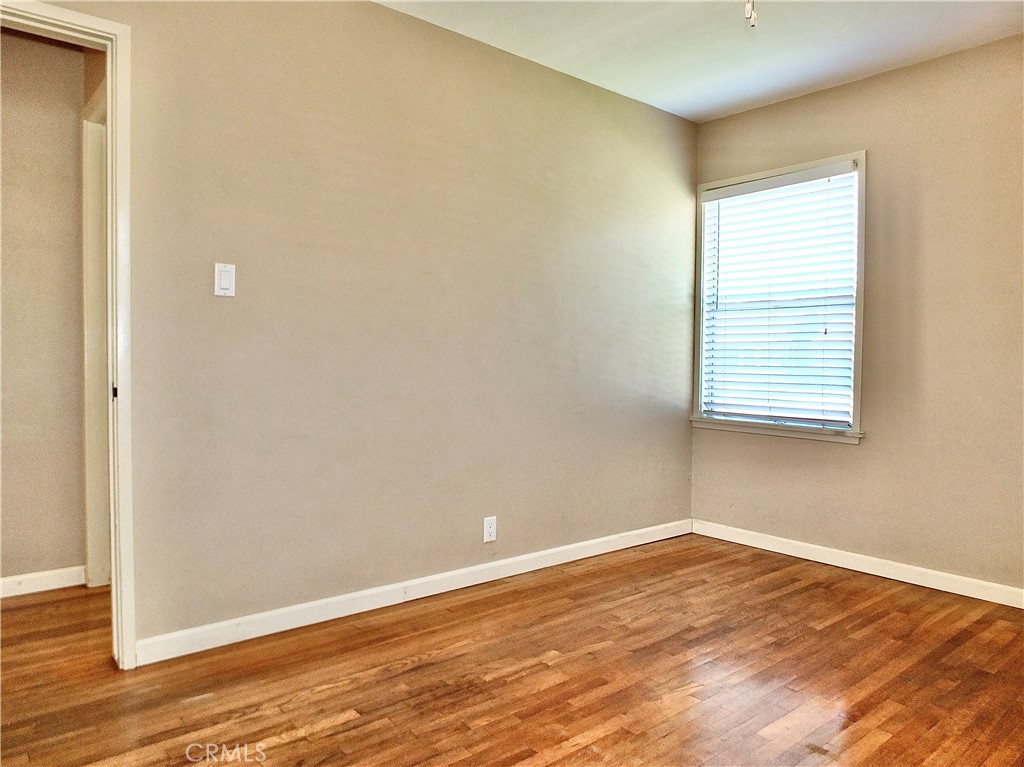 2024 San Anseline Avenue Long Beach, CA 90815 - Photo 35 of 36 an empty room with wooden floor and windows
