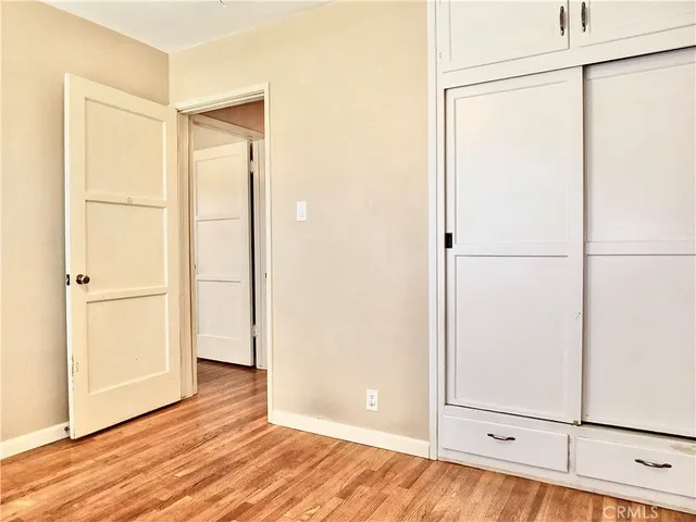 a view of a room with wooden floor