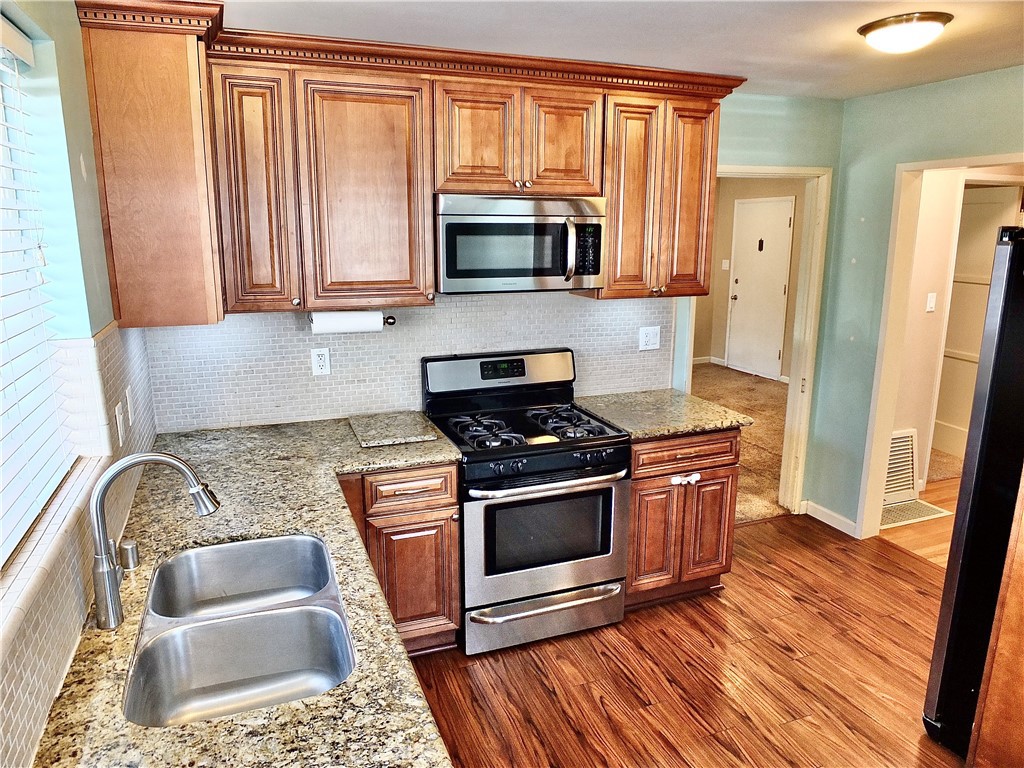 2024 San Anseline Avenue Long Beach, CA 90815 - Photo 4 of 36 a kitchen with granite countertop a sink stove and refrigerator