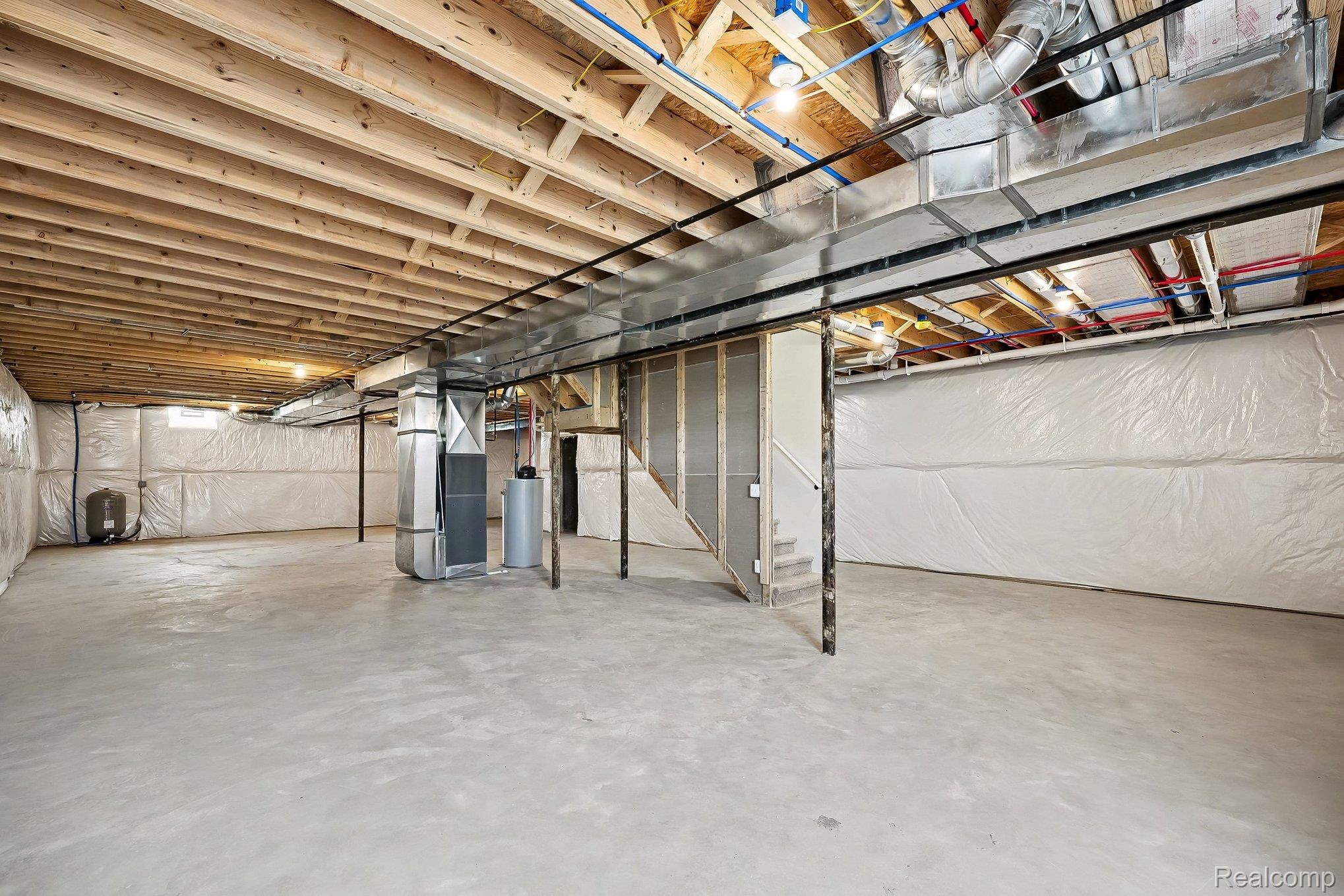 57560 Omo Road Ray, MI 48096 - Photo 35 of 44 Unfinished 9' basement featuring concrete flooring, exposed wood joists, and visible utility infrastructure including ductwork and plumbing