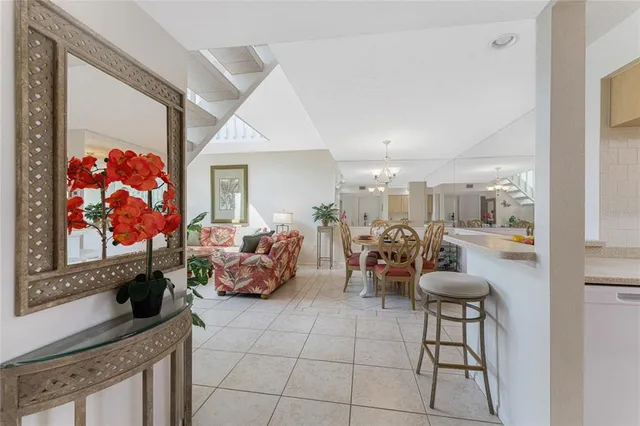 a kitchen with stainless steel appliances kitchen island granite countertop a refrigerator and a sink