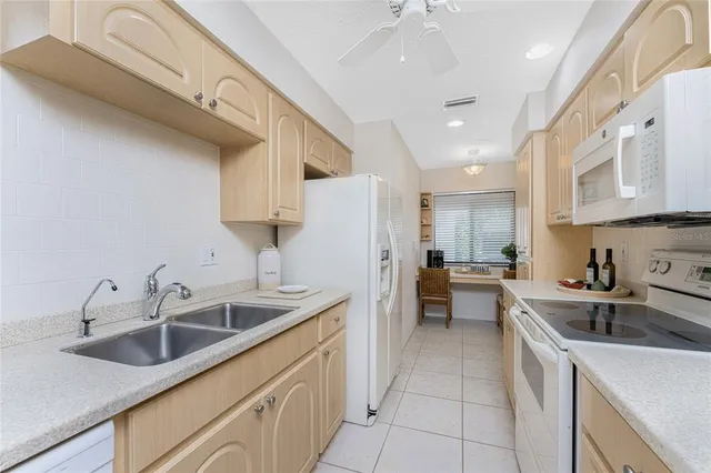 a bathroom with a sink and a potted plant